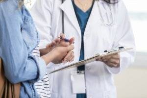 female doctor discussing medical chart with patient